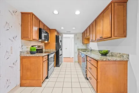 a kitchen with stainless steel appliances granite countertop a sink and cabinets