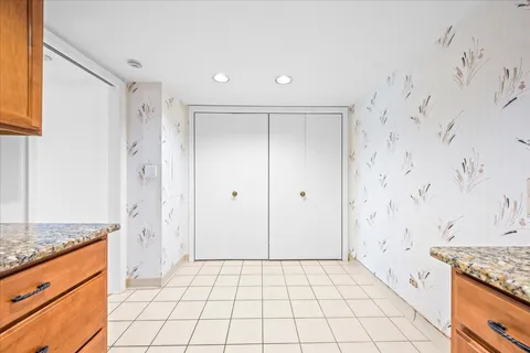 a spacious bathroom with a granite countertop sink a mirror and a shower