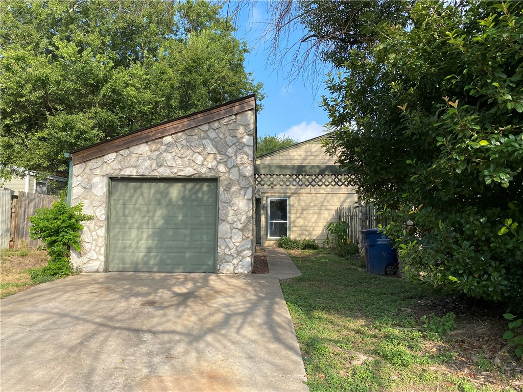 919 Sirocco Drive, Unit A Austin, TX 78745 - Photo 1 of 10 a front view of a house with a yard and trees