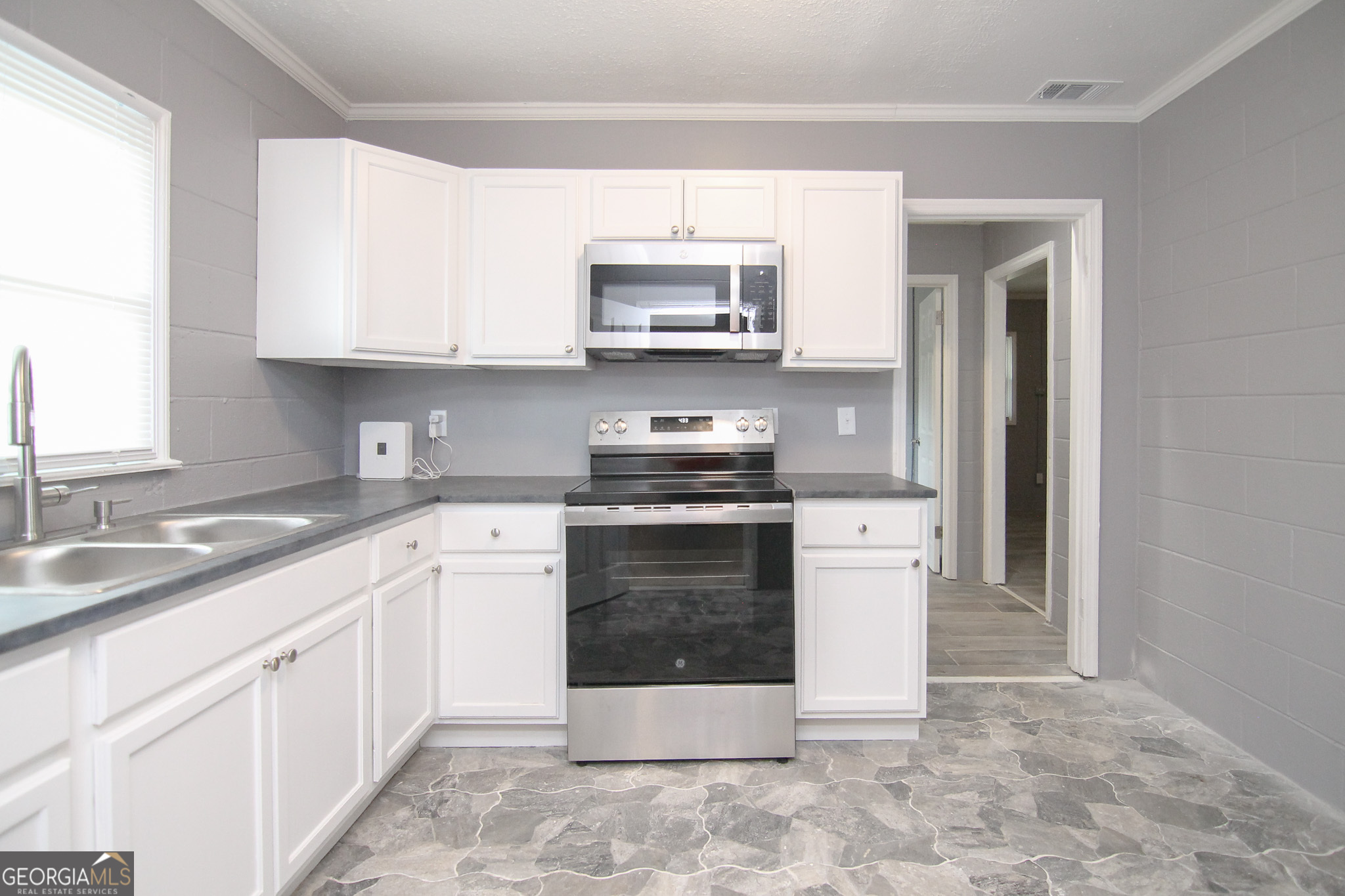 708 South 3rd Street Warner Robins, GA 31088 - Photo 25 of 29 a kitchen with a stove sink and cabinets