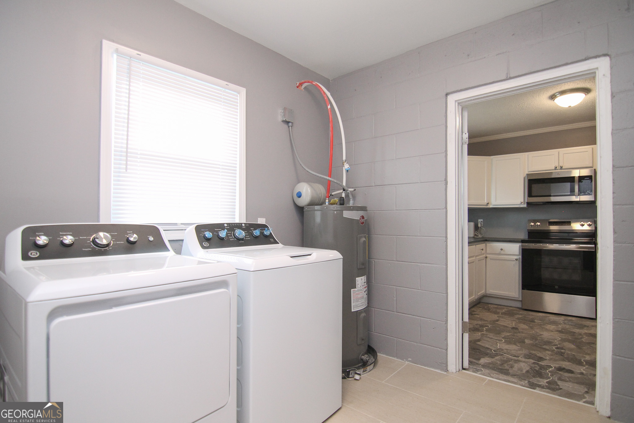708 South 3rd Street Warner Robins, GA 31088 - Photo 6 of 29 a view of washer and dryer with bathroom in the background
