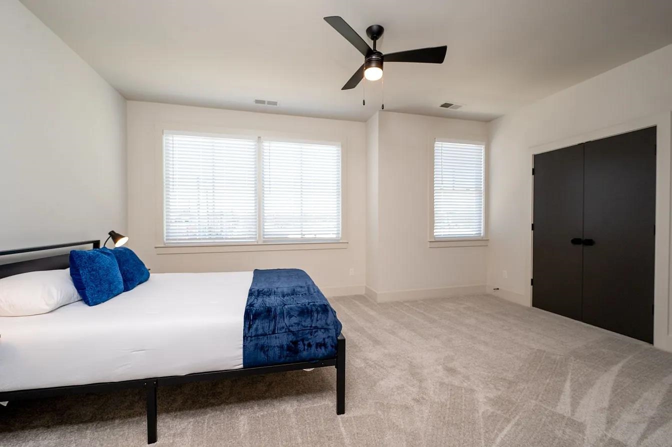 752 Meda Street Memphis, TN 38104 - Photo 11 of 18 Bright interior space featuring light-toned carpeting and multiple windows with blinds
