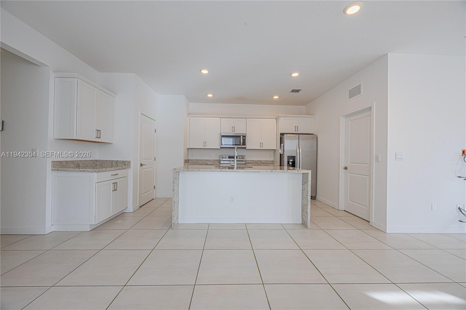 7214 Rockwood Road Jupiter, FL 33458 - Photo 15 of 28 a view of kitchen with granite countertop cabinets and white appliances