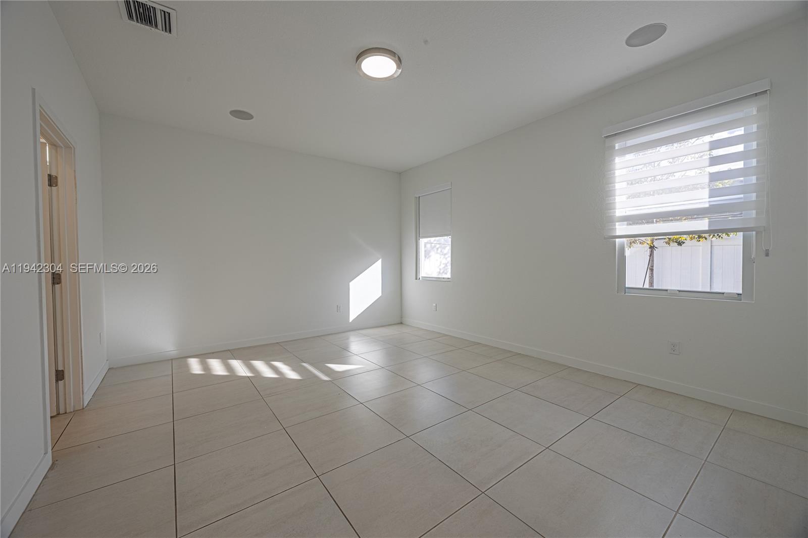 7214 Rockwood Road Jupiter, FL 33458 - Photo 20 of 28 a view of an empty room and window