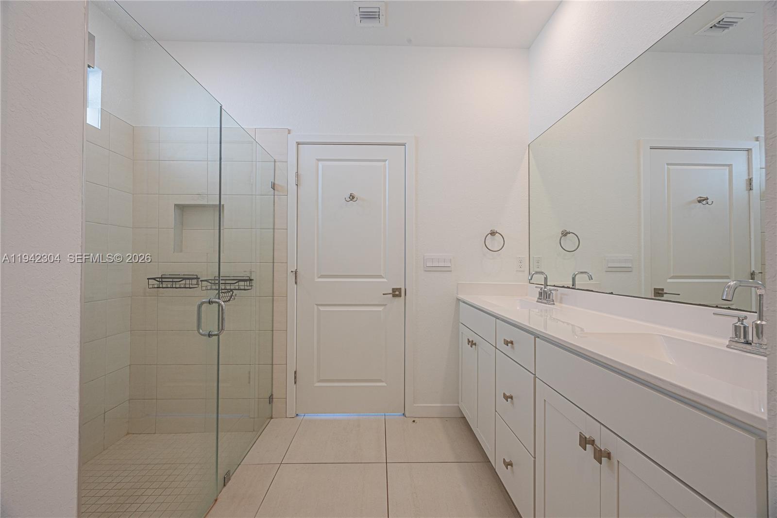 7214 Rockwood Road Jupiter, FL 33458 - Photo 23 of 28 a spacious bathroom with a shower and a sink