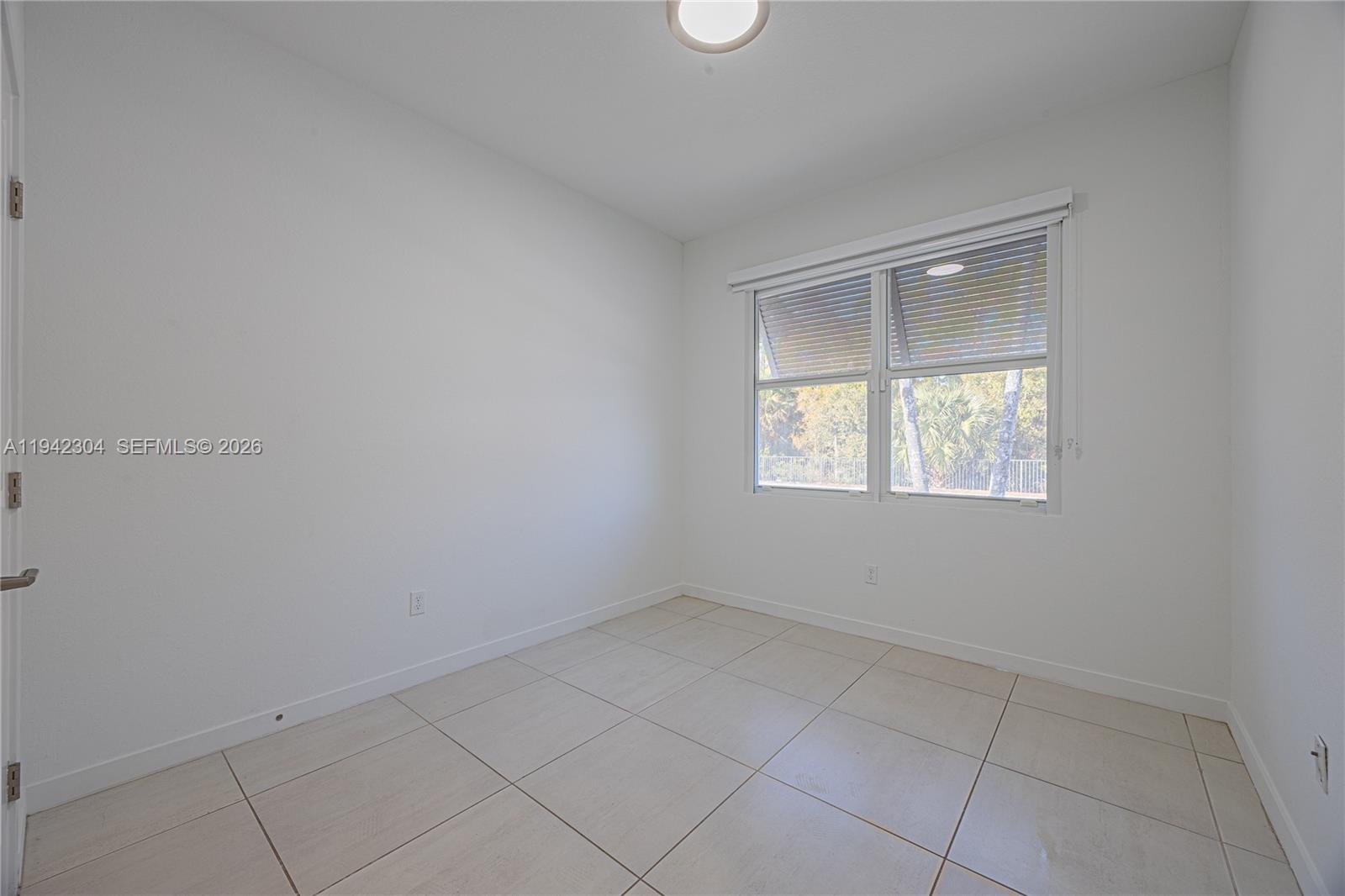 7214 Rockwood Road Jupiter, FL 33458 - Photo 4 of 28 an empty room with a window