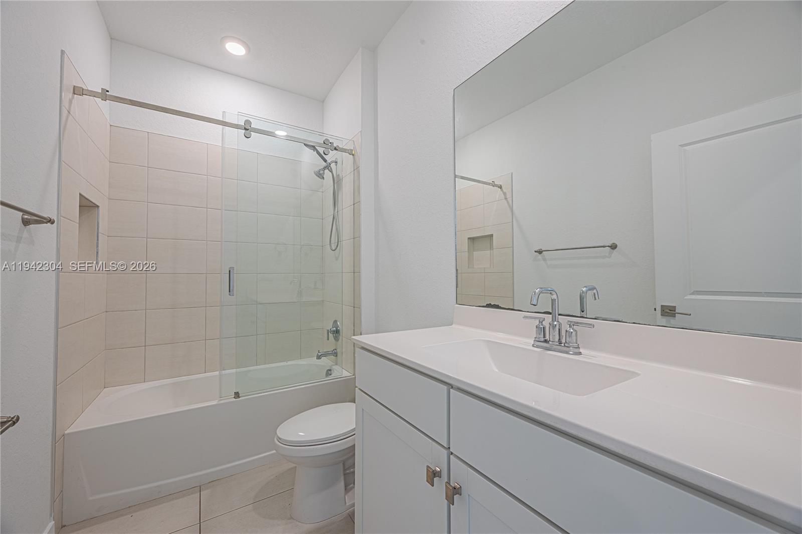 7214 Rockwood Road Jupiter, FL 33458 - Photo 6 of 28 a bathroom with a sink a toilet and shower