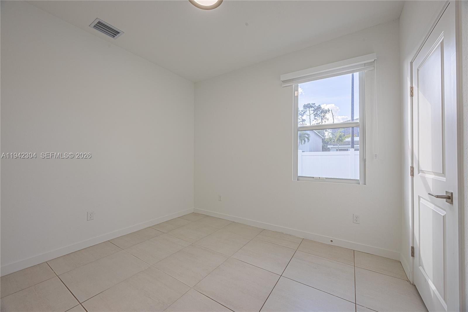 7214 Rockwood Road Jupiter, FL 33458 - Photo 7 of 28 an empty room with windows