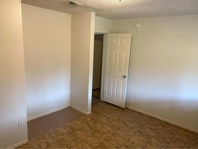 an empty room with closet area