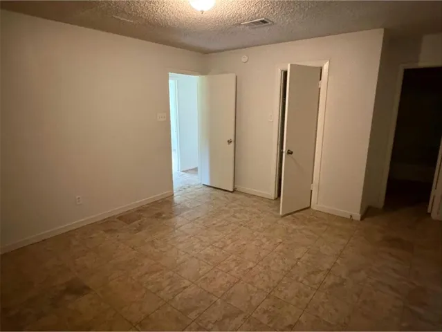 an empty room with closet area