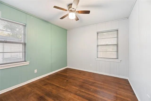 a view of a room with wooden floor and windows