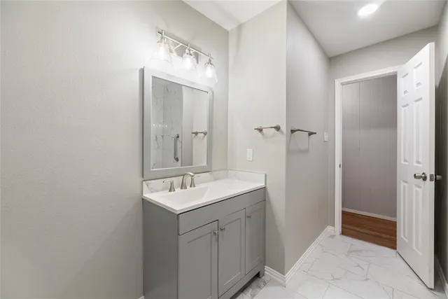 a bathroom with a sink mirror and shower
