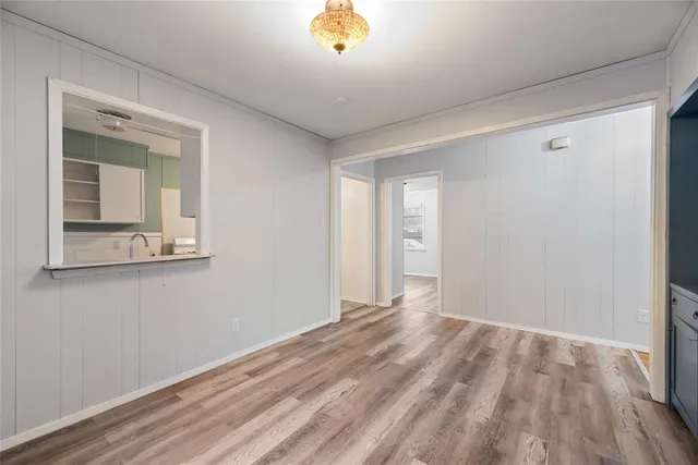 a view of a room with wooden floor and a window