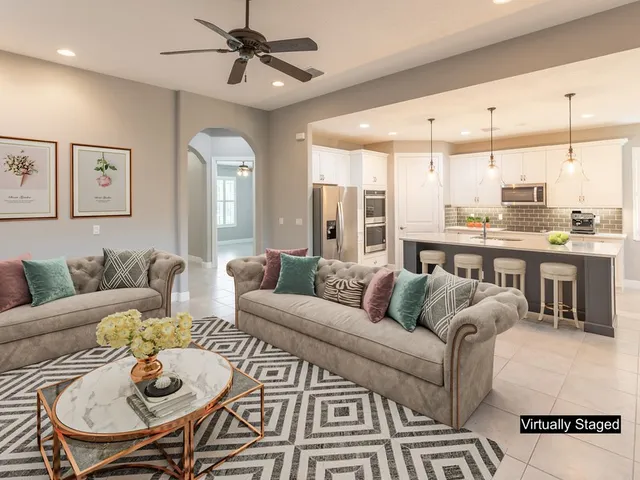 a living room with furniture ceiling fan and a rug