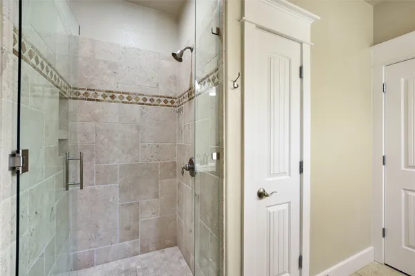 a bathroom with a glass shower door