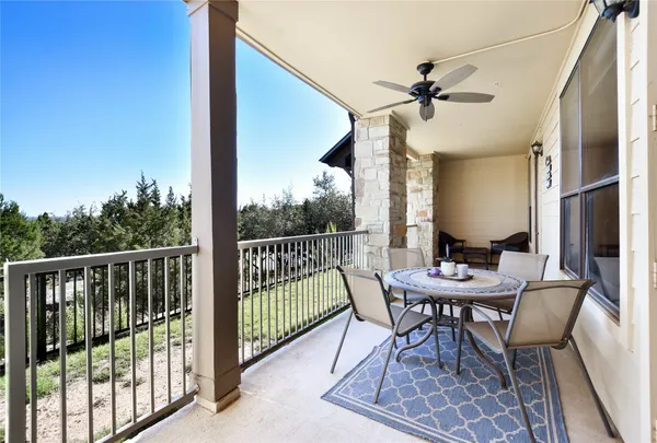 a view of a balcony dining table and chairs