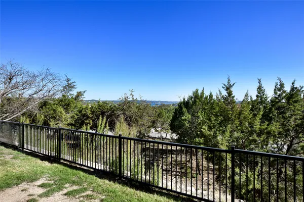 a view of a balcony with a forest