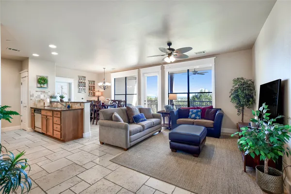 a living room with furniture potted plant and a flat screen tv