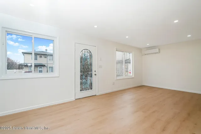 a view of a kitchen with a refrigerator a kitchen view and wooden floor