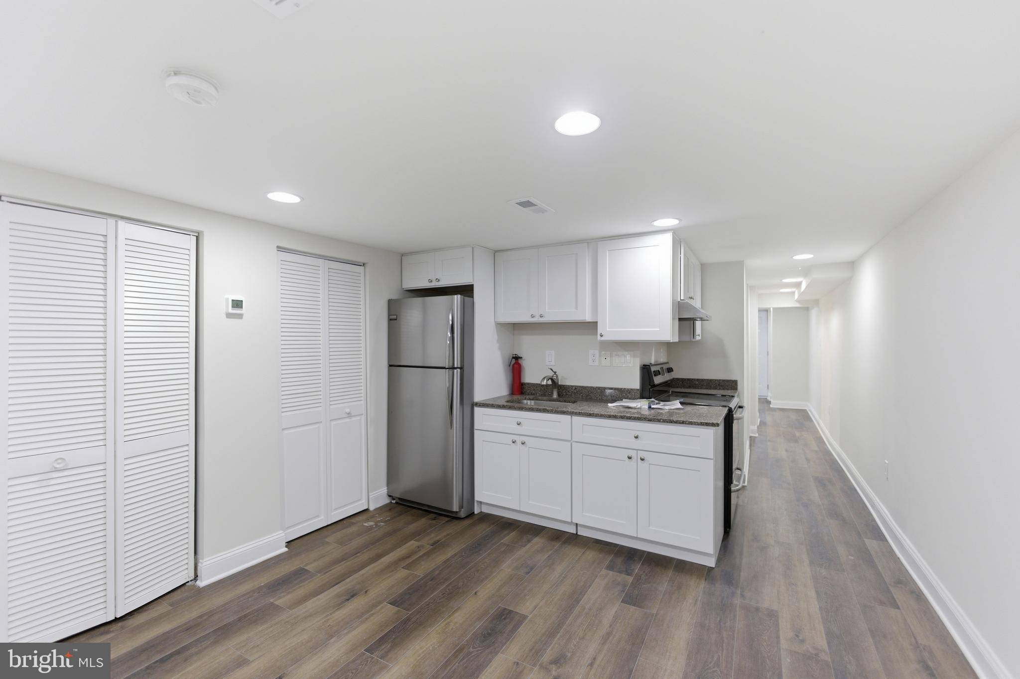 10 Girard Street Northeast Washington, DC 20002 - Photo 11 of 31 a kitchen with stainless steel appliances granite countertop a stove a sink and a refrigerator