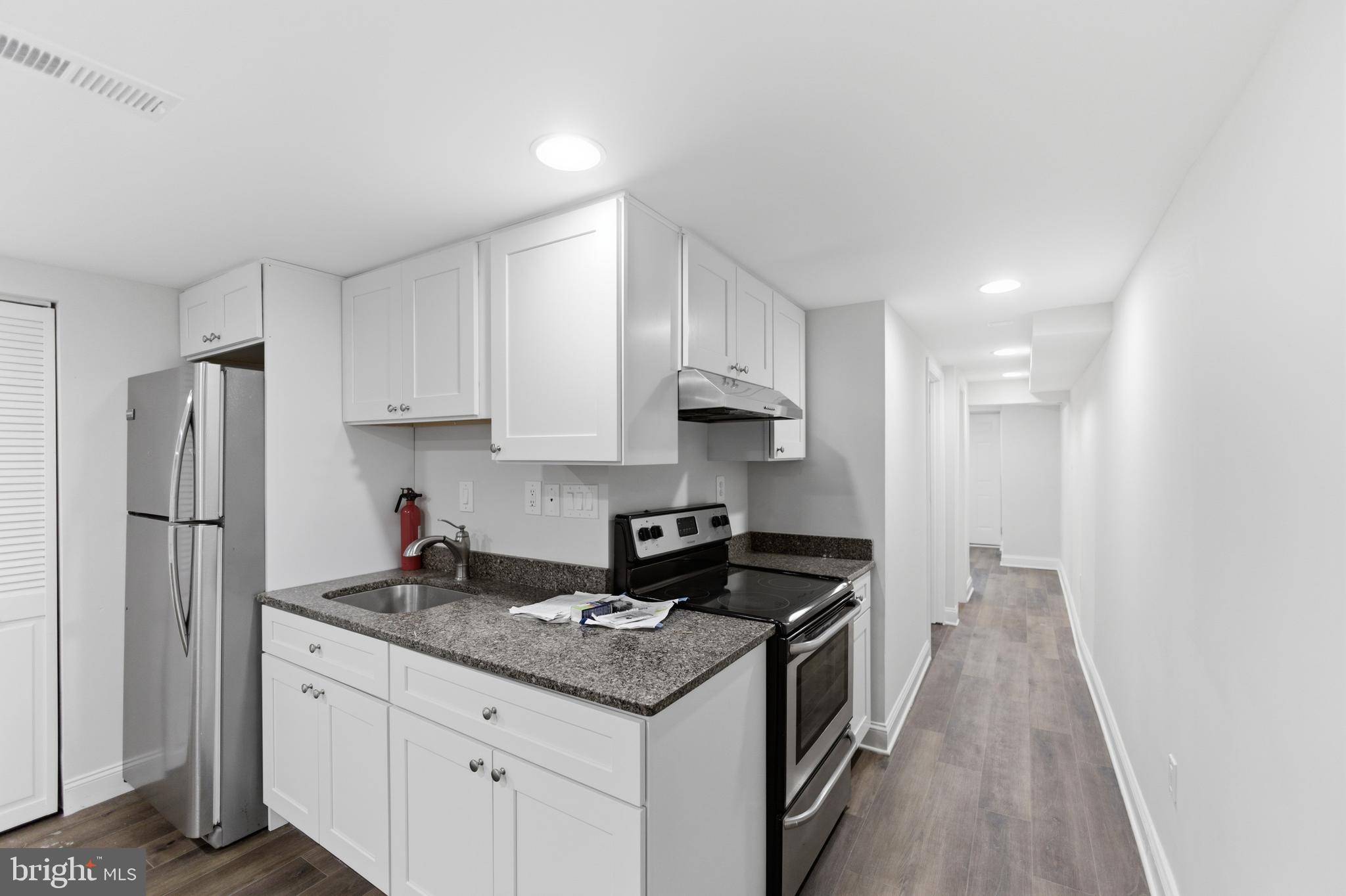 10 Girard Street Northeast Washington, DC 20002 - Photo 13 of 31 a kitchen with stainless steel appliances granite countertop a stove a refrigerator and a sink