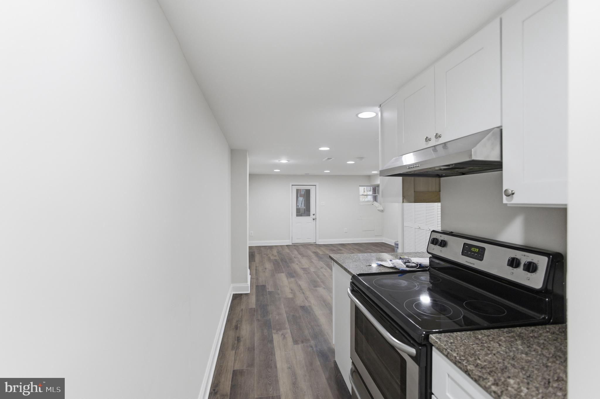 10 Girard Street Northeast Washington, DC 20002 - Photo 15 of 31 a kitchen with granite countertop a stove and a sink