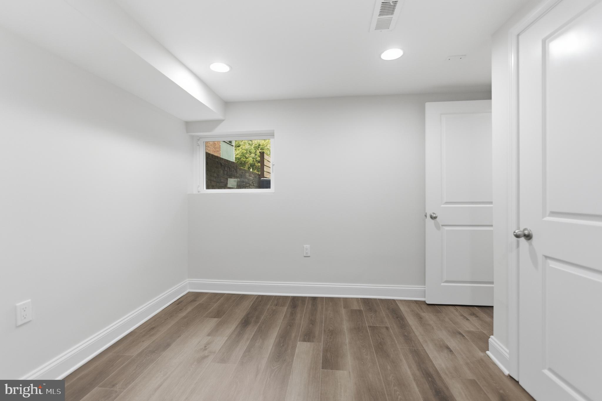 10 Girard Street Northeast Washington, DC 20002 - Photo 16 of 31 a view of room with window and wooden floor