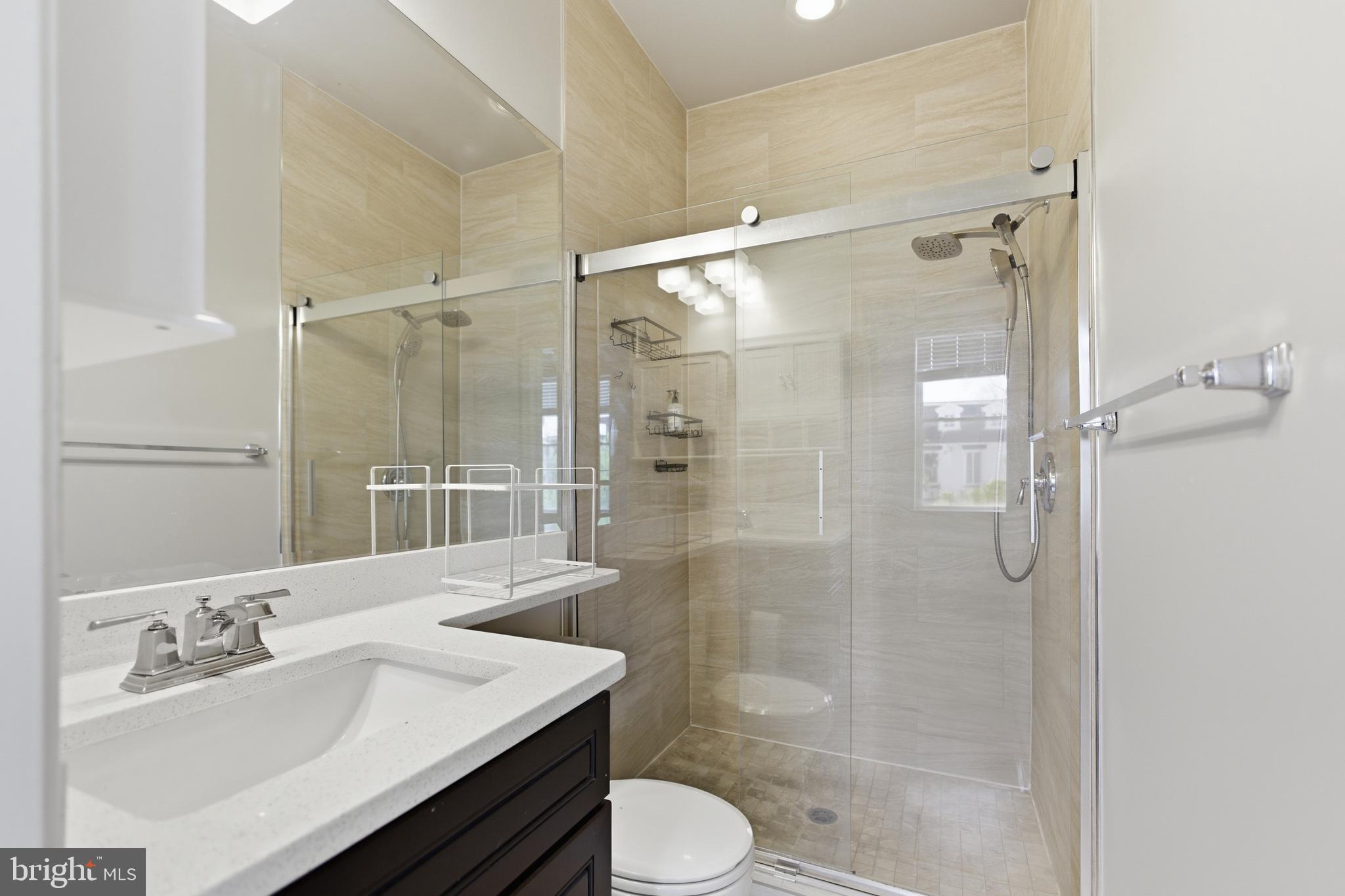 10 Girard Street Northeast Washington, DC 20002 - Photo 19 of 31 a bathroom with a sink toilet and shower