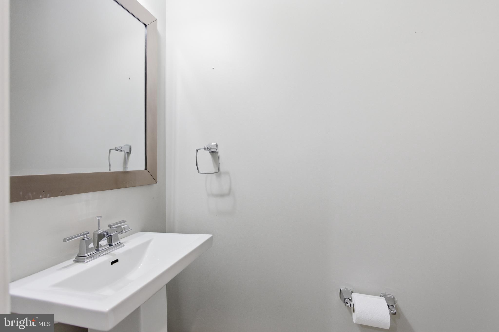 10 Girard Street Northeast Washington, DC 20002 - Photo 20 of 31 a bathroom with a sink and a mirror