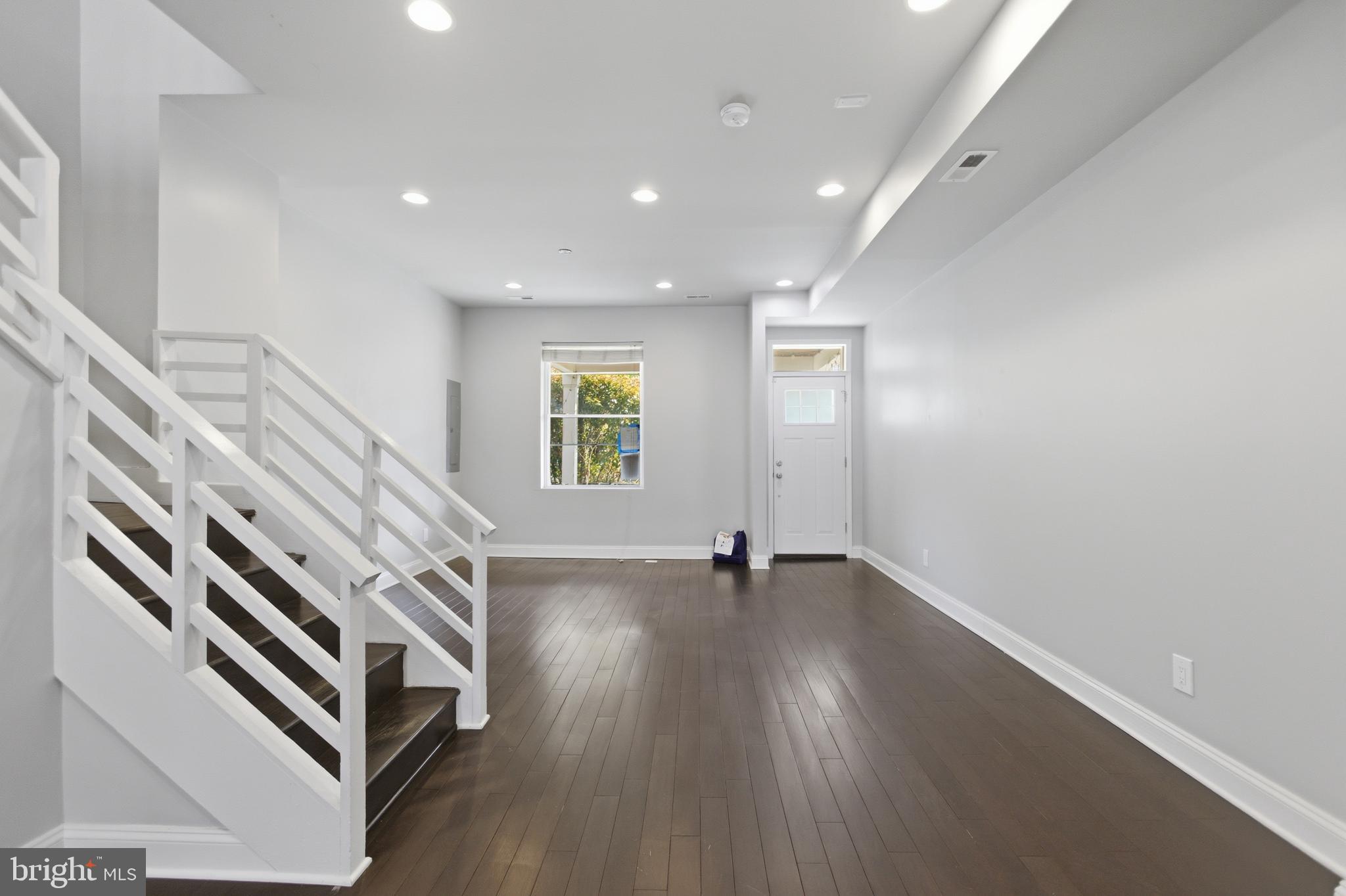 10 Girard Street Northeast Washington, DC 20002 - Photo 2 of 31 wooden floor in an empty room with a window