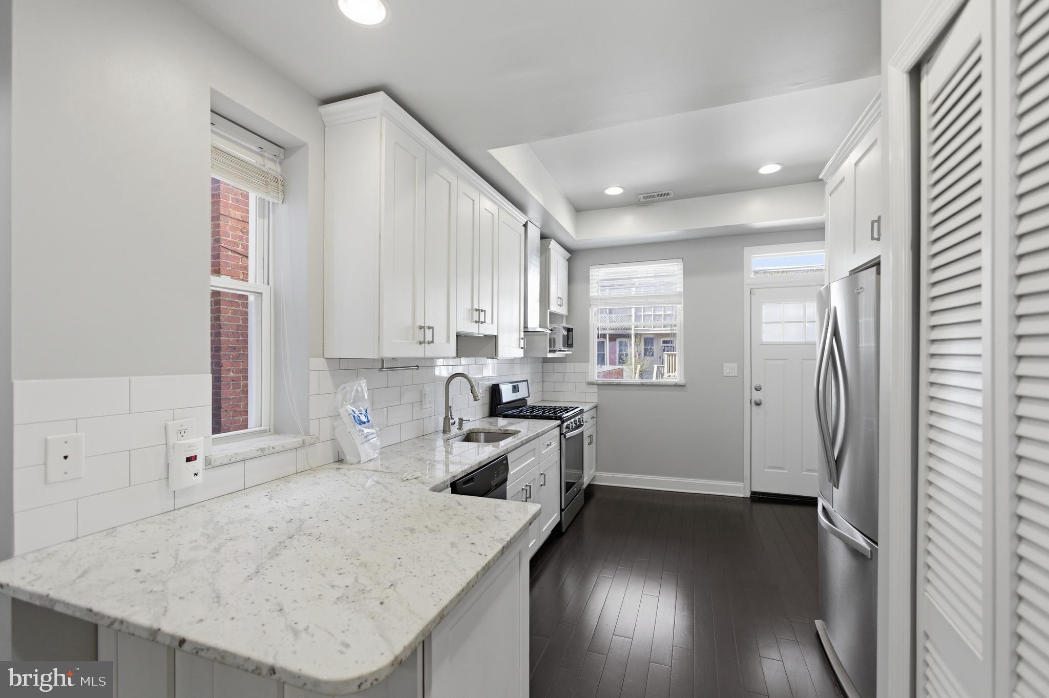 10 Girard Street Northeast Washington, DC 20002 - Photo 23 of 31 a kitchen with a sink stove and refrigerator