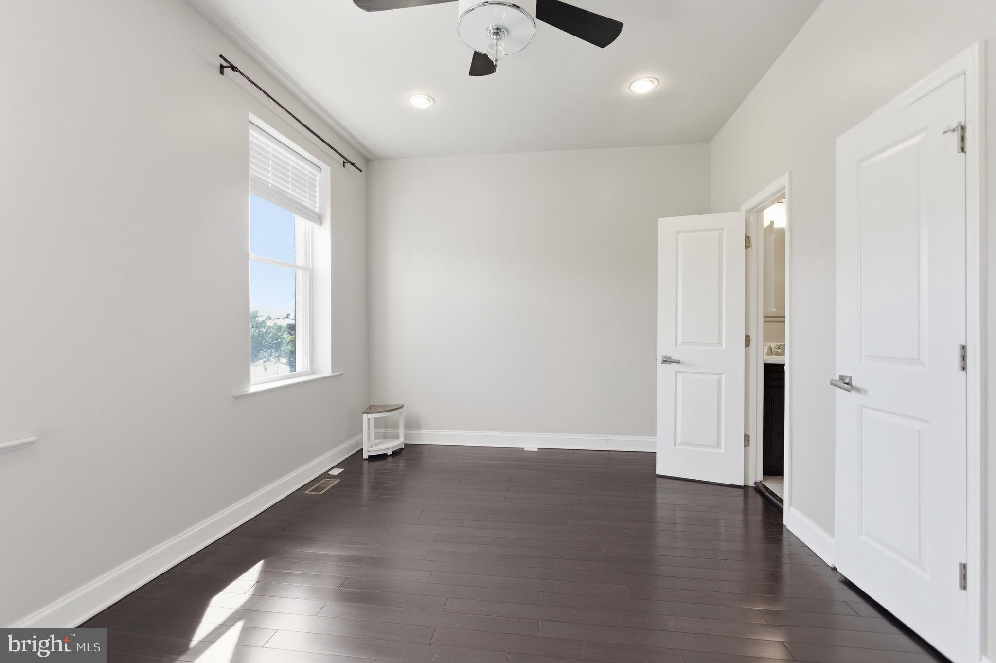 10 Girard Street Northeast Washington, DC 20002 - Photo 27 of 31 an empty room with wooden floor and windows