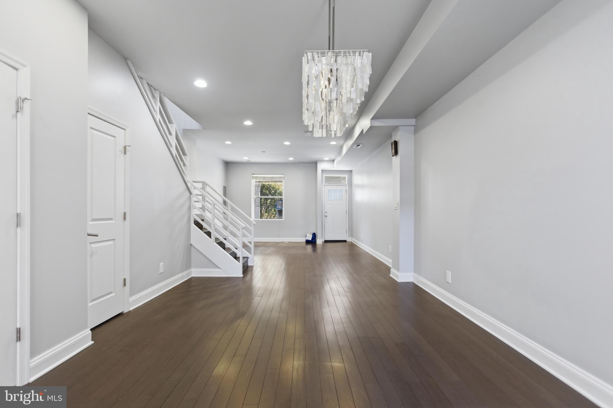 10 Girard Street Northeast Washington, DC 20002 - Photo 5 of 31 a view of a hallway with wooden floor and chandelier