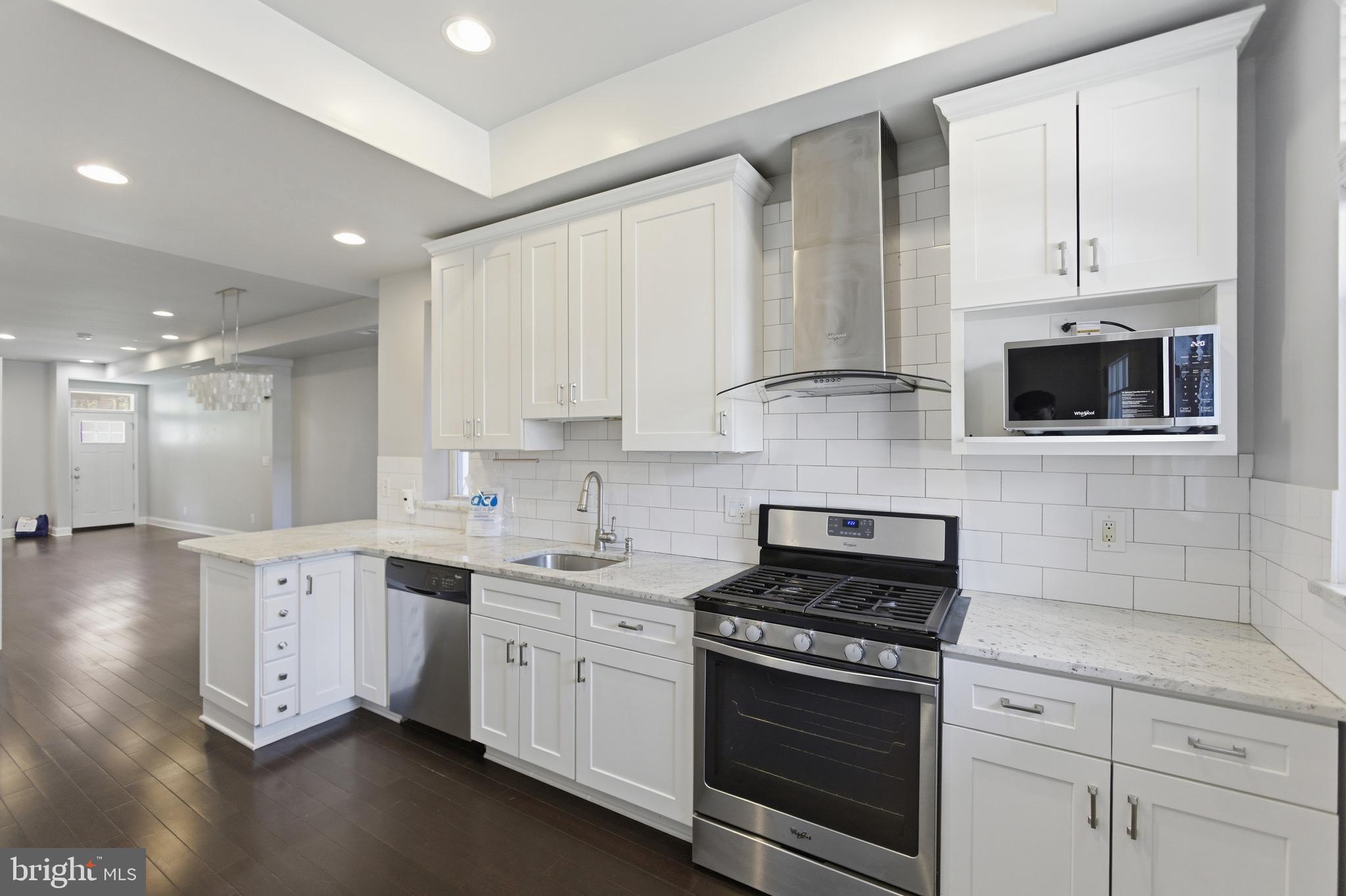 10 Girard Street Northeast Washington, DC 20002 - Photo 9 of 31 a kitchen with stainless steel appliances white cabinets and a sink