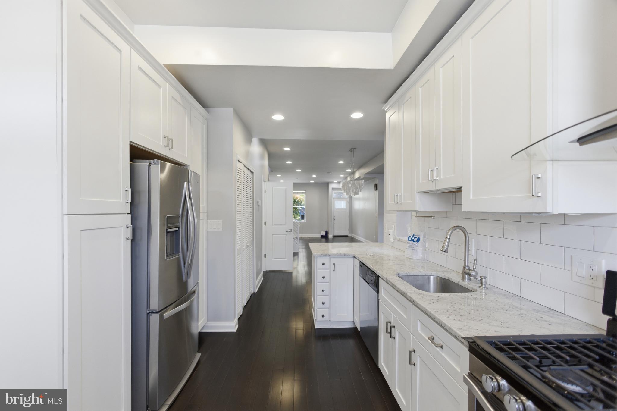 10 Girard Street Northeast Washington, DC 20002 - Photo 10 of 31 a kitchen with stainless steel appliances a sink stove and refrigerator