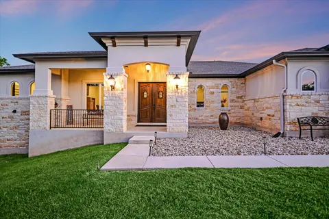 a front view of a house with a garden