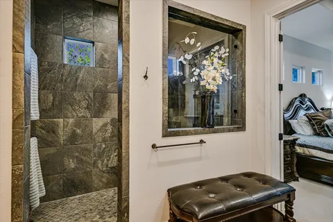 a bedroom with a bed and flat screen tv