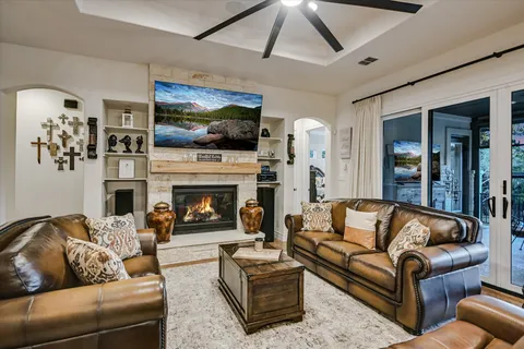 a living room with furniture fireplace and flat screen tv