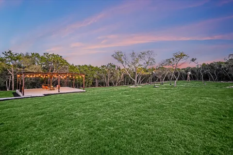 a view of a backyard with sitting area