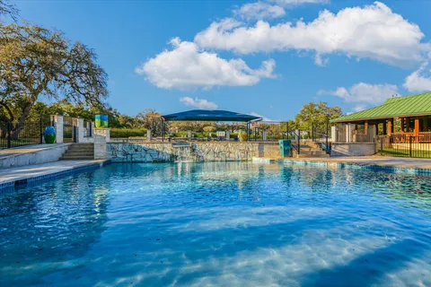 a view of a swimming pool with a yard