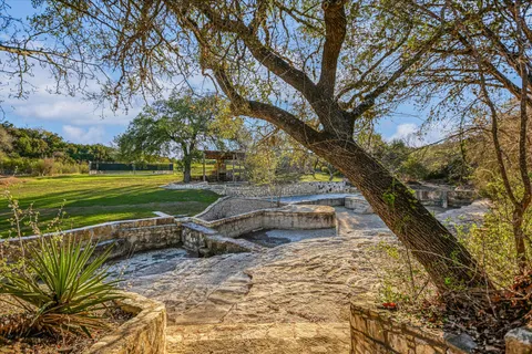 a view of backyard with swimming pool and outdoor seating