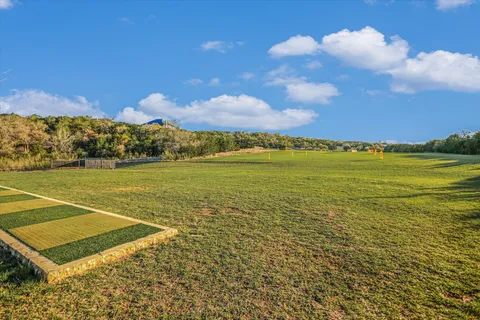 a view of a yard with wooden fence