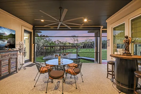 a dining room with furniture and a floor to ceiling window