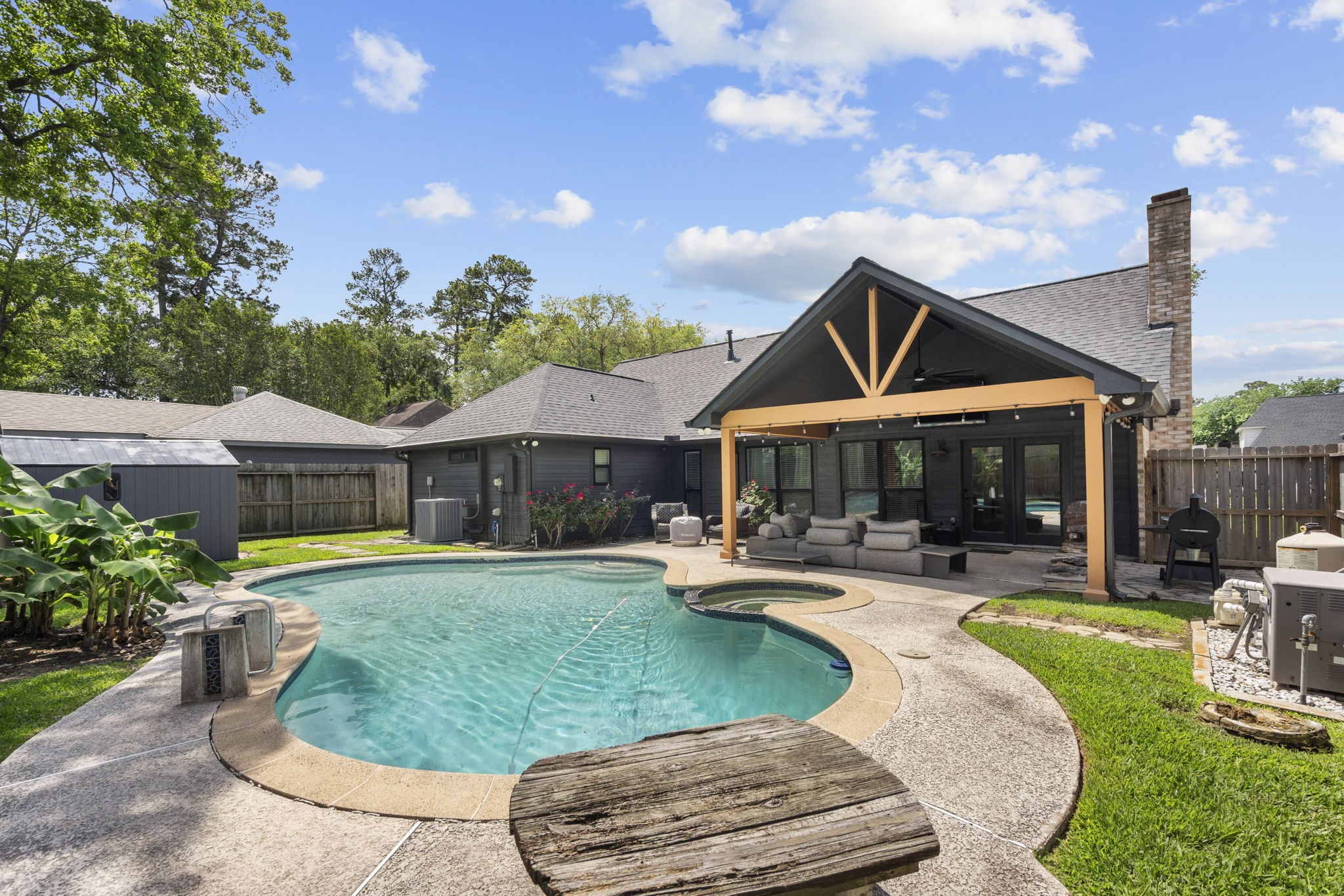 a view of a house with swimming pool and sitting area