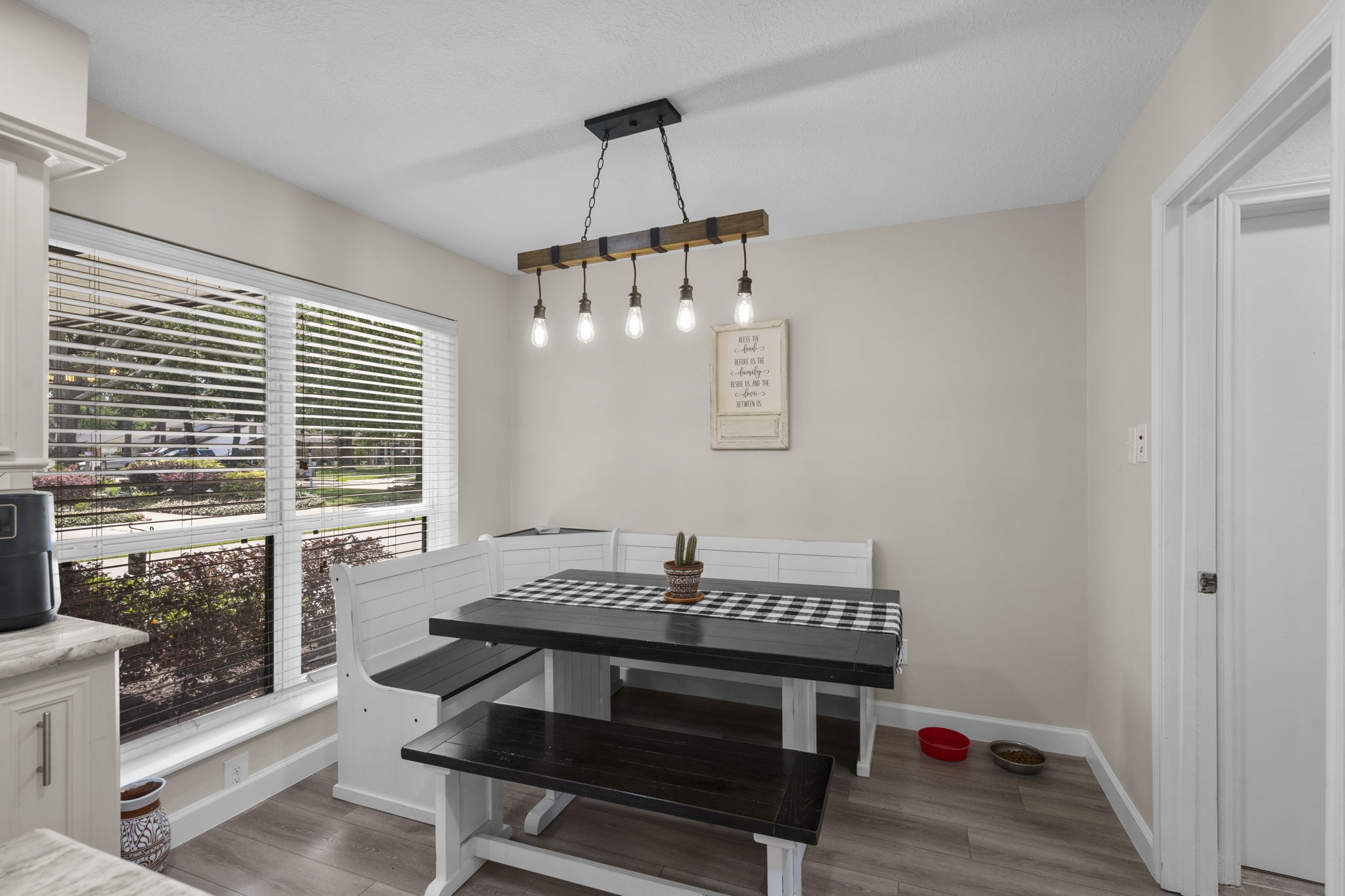 19602 Dianeshire Drive Spring, TX 77388 - Photo 17 of 37 Cozy dining nook enhanced by stylish pendant lighting. Large windows provide ample natural light, creating a bright and inviting space.
