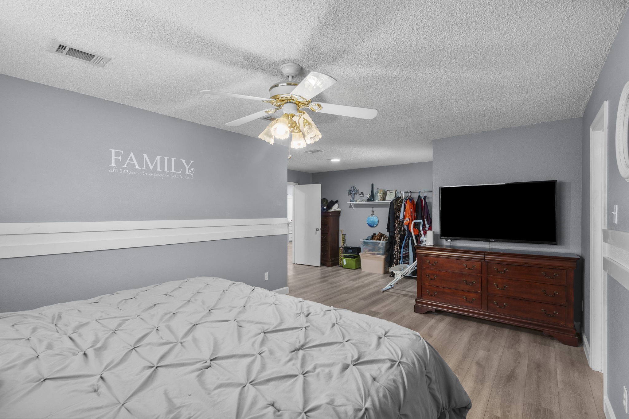 19602 Dianeshire Drive Spring, TX 77388 - Photo 25 of 37 a bedroom with a bed and a flat tv screen on dresser