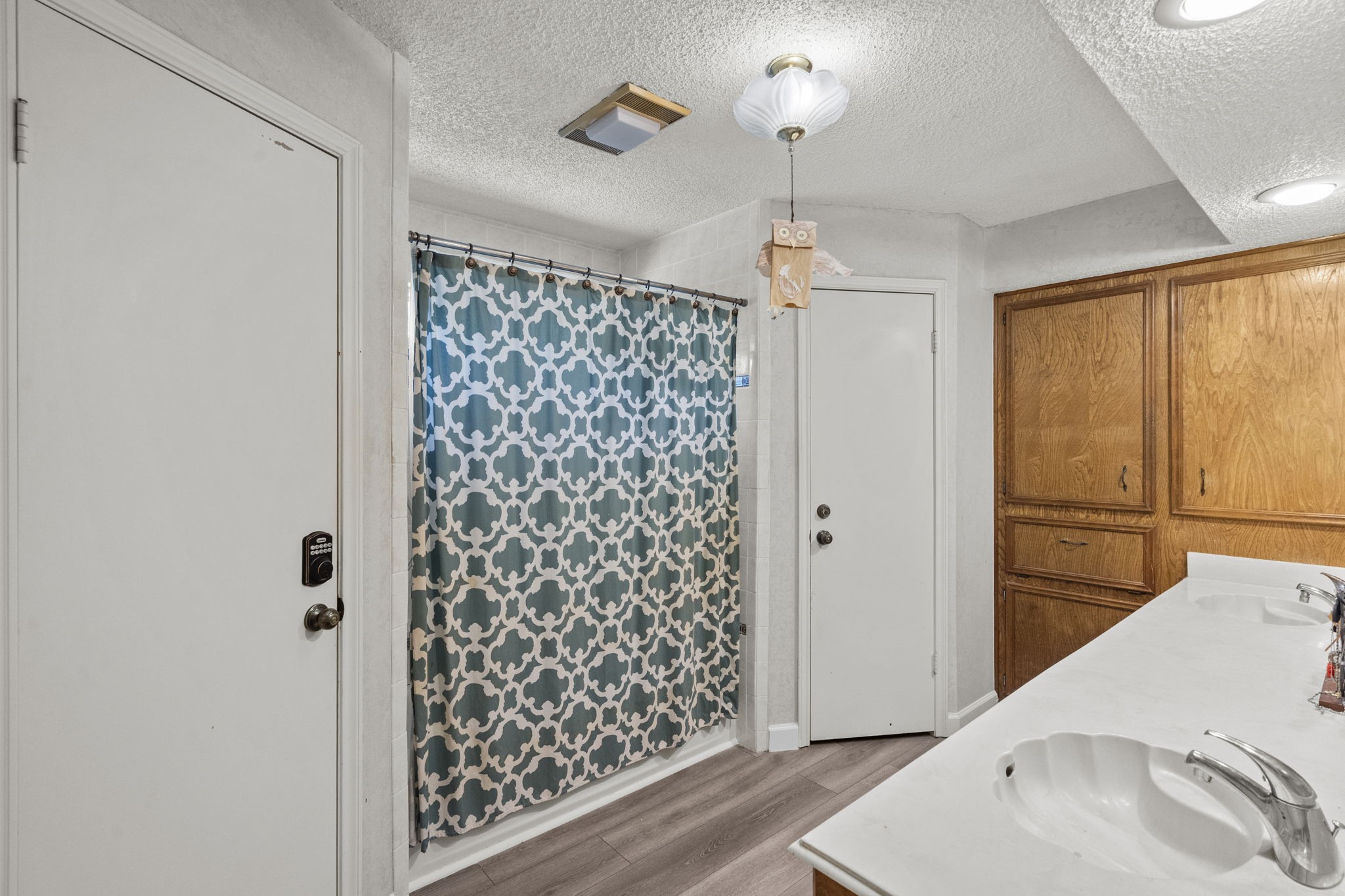 19602 Dianeshire Drive Spring, TX 77388 - Photo 26 of 37 Primary bathroom featuring a dual sink vanity with wooden cabinetry, tub/shower combo.