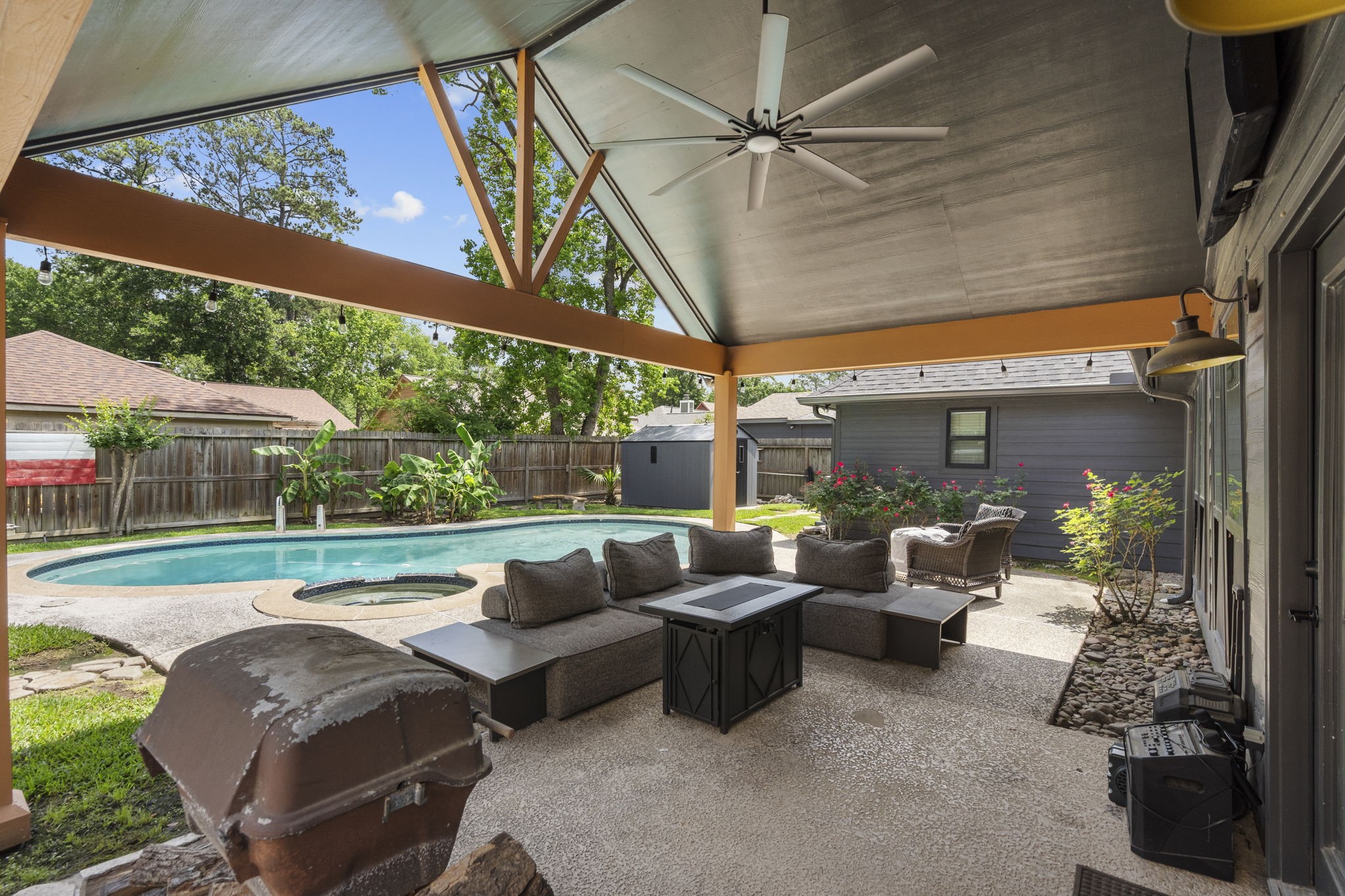 19602 Dianeshire Drive Spring, TX 77388 - Photo 3 of 37 Backyard oasis featuring a large covered patio with a view of the well-maintained pool and spa.
