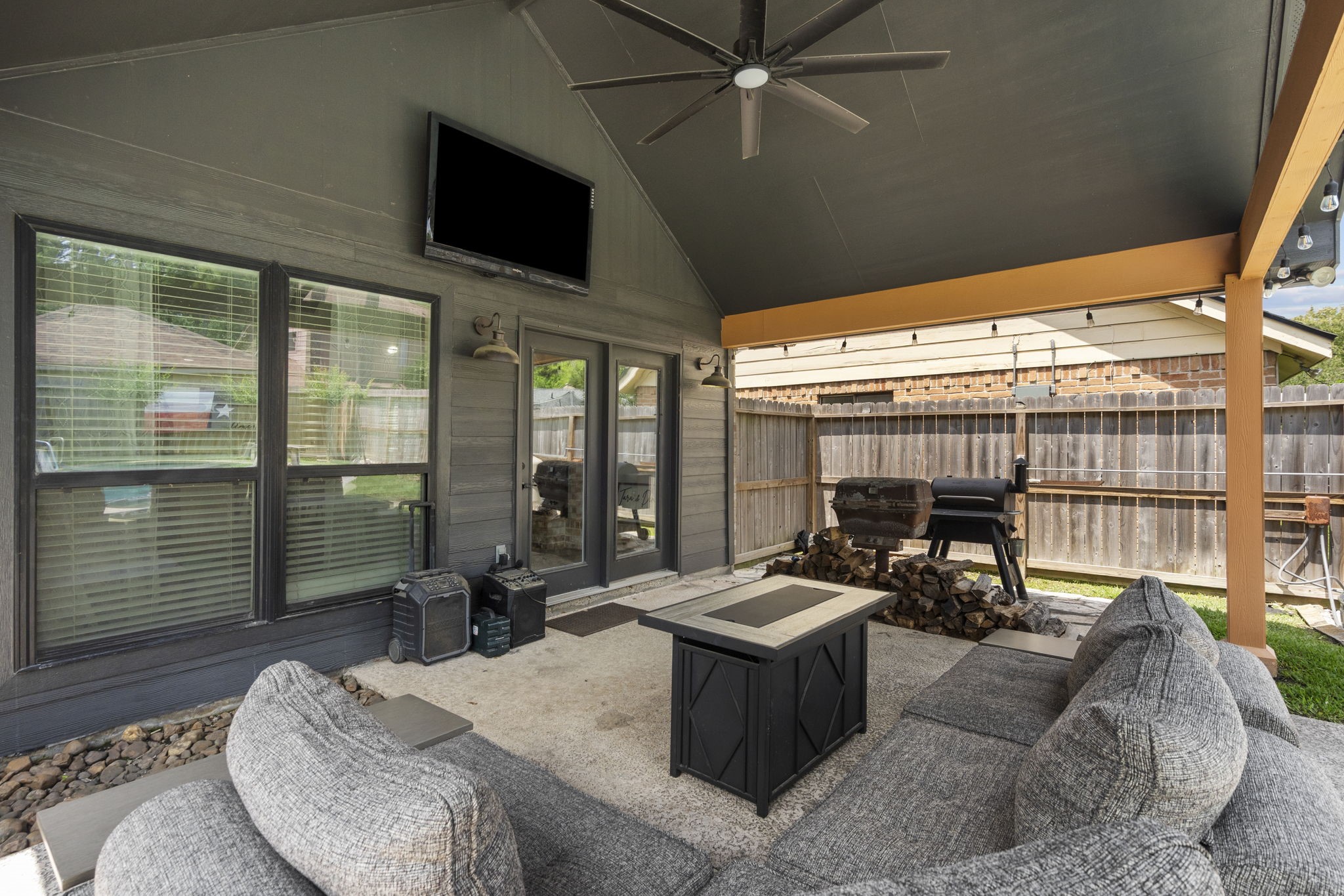 19602 Dianeshire Drive Spring, TX 77388 - Photo 34 of 37 a living room with couches a flat screen tv and a floor to ceiling window