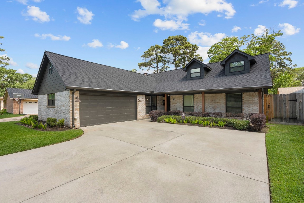 19602 Dianeshire Drive Spring, TX 77388 - Photo 4 of 37 Charming home featuring a modern exterior with a spacious driveway and two-car garage.
